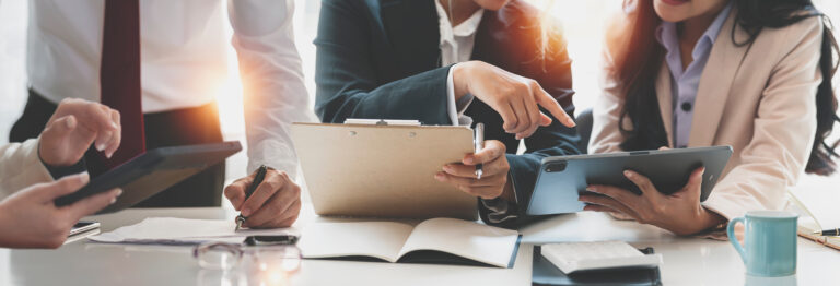 Cropped shot of diverse coworkers working together in boardroom,